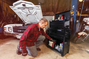 Photo of a person kneeling in front of a black Craftsman rolling tool chest, SKU CMST22653BK, in a garage setting.